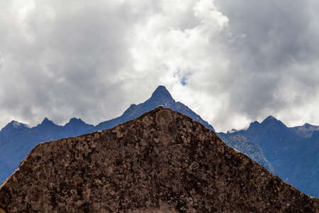 Machu Picchu, Peru - April 6, 2014: The sacred rock and monolith of Machu Picchu, silhouetted against the mountain line, Peru.のeditorial素材