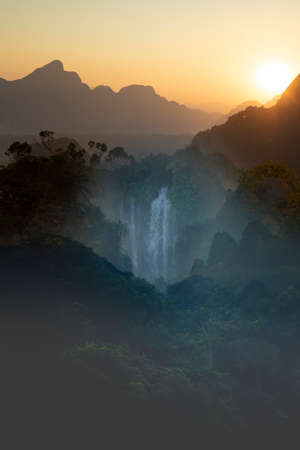 Fantastic fictional landscape with waterfall, created digitally with photographs of landscapes from...
