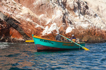 Local fishermen inspect the waters surrounding the Ballestas Islands by boat, within the protected area of the Paracas national reserve, north coast of the Paracas peninsula, Pisco, Ica, Peru.のeditorial素材