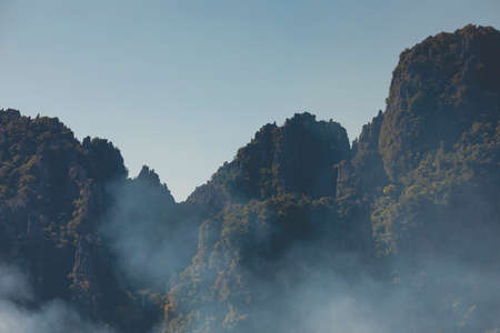 Landscape photography of karst mountains and their silhouettes, from the city of Vang Vieng, Laos, covered with forests formed by lush green tropical trees. Vientiane province.の写真素材