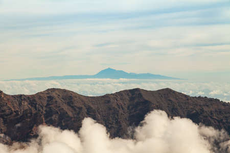 Impressive landscape of clouds and volcanic mountains from the top of the Roque de los Muchachos viewpoint, on the island of La Palma, Canary Islands, Spain.の写真素材