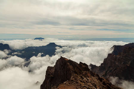 Impressive landscape of clouds and volcanic mountains from the top of the Roque de los Muchachos viewpoint, on the island of La Palma, Canary Islands, Spain.の写真素材