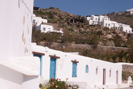 Mykonos, Greece - April 05, 2012: Empty whitewashed little houses, without people, in spring, on the island of Mykonos, Cyclades islands in the Aegean sea. Charming place not far from Elia Beach.のeditorial素材