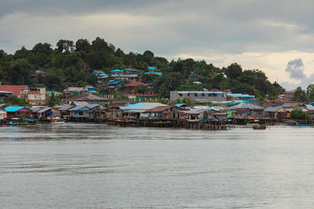 Sorong, Indonesia - October 18, 2019: Skyline of humble little houses by the sea in the town of Sorong, West Papua, near the arrival area of the Waisai to Sorong ferry.のeditorial素材