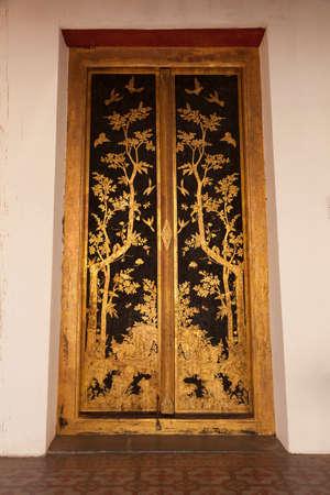 Bangkok, Thailand - March 25, 2018: Huge golden door in Phutthaisawan Hall, decorated with sumptuous plant motifs, in the grounds of the Bangkok National Museum, an example of Thai architecture.のeditorial素材