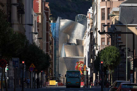 Bilbao, Spain - August 16, 2020: General view of the buildings and homes of Iparraguirre street, downtown Bilbao. In the background you can see the Guggenheim museum and the Archanda mountain.のeditorial素材