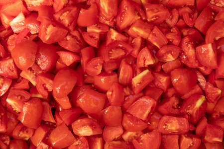 Preparation of homemade preserves, handmade, with seasonal, local products. Dozens of plum tomatoes, washed, sliced and cooked with olive oil, sugar and salt, in Aragon, Spain.の写真素材