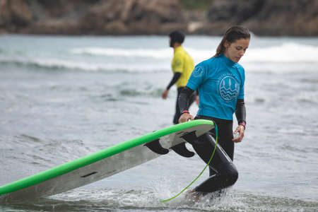 Galicia, Spain - August 2, 2020: Surf lessons on the beach of San Antonio, Espasante. Novice...