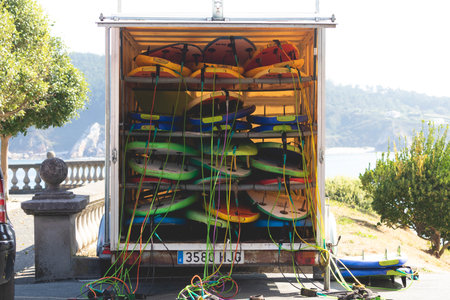 Galicia, Spain - August 4, 2020: A pile of surfboards and sports equipment with their leash stored...