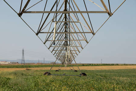 Gallur, Spain - July 27, 2020: Irrigation pivot, with water or chemigation, fed by pipeline, example of agricultural machinery and agro-industrial infrastructures in crop fields in Aragon.のeditorial素材