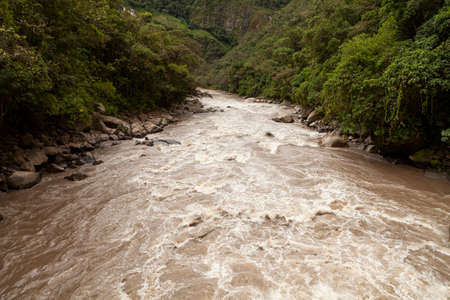 Turbulent waters of the Urubamba or Vilcanota river, crossing the Amazon cloud forest, as it passes...