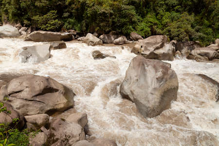 Turbulent waters of the Urubamba or Vilcanota river, crossing the Amazon cloud forest, as it passes...