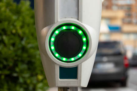 A battery charging point for electric cars, illuminated with green LEDs, in the area of the Retiro...