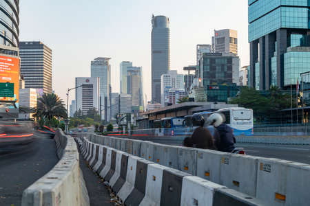 Jakarta, Indonesia - Oct 20, 2019: Skyline of skyscrapers in Jakarta and bus and motorcycle traffic on Jend Sudirman streetのeditorial素材
