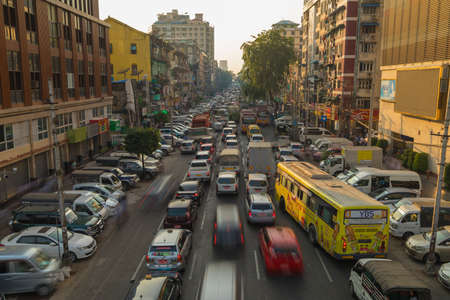 Yangon, Myanmar - December 19, 2019: Rush hour and traffic jams in Yangon city, downtown district, above Anawrahta Rd, taken from the crosswalkのeditorial素材