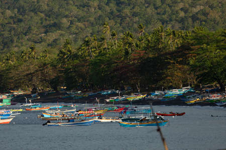 Batu Putih, Indonesia - September 30, 2019: Dozens of colorful fishing boats moored near the beach, Tangkoko Nature Park, Sulawesi, Indonesiaのeditorial素材