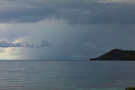 Huge storm clouds on a rainy day, over the horizon and the Friwin islands, passing through the Raja...