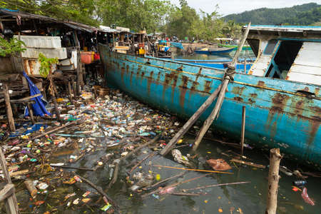 Waisai, Indonesia - Oct 17, 2019: A huge sunken ship, surrounded by garbage, plastics, bottles and debris on the water, Raja Ampat islandsのeditorial素材