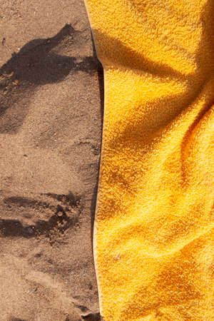 Texture of sand and towel cloth, of intense color, extended to the sun, on Arrigunaga beach, near Bidezabal, Basque Country, Spainの写真素材