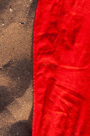 Texture of sand and towel cloth, of intense color, extended to the sun, on Arrigunaga beach, near Bidezabal, Basque Country, Spainの写真素材