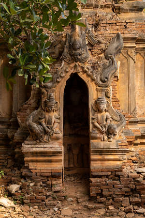 Buddhist figures and reliefs in one of the ancient red brick stupas and pagodas, in Nyaung Ohak, Shwe Indein Pagoda, Shan State, Myanmarの写真素材