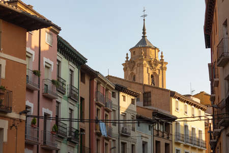 View of the tower and bell tower of the Basilica of San Lorenzo, and the houses that surround it, in the city of Huesca, Spain, from Coso Bajo streetの写真素材