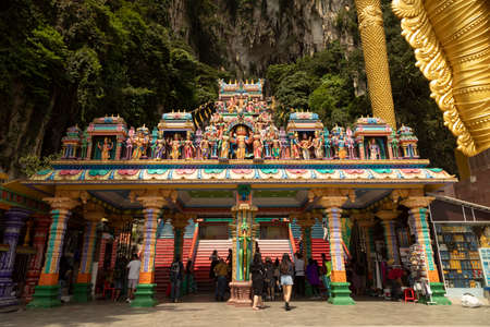 Batu Caves, Malaysia - Nov 04, 2019: Several people pass through the access and entrance area to the stairs to the Batu Caves, in Gombak District, Selangor, Malaysiaのeditorial素材
