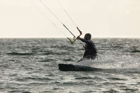 Ortigueira, Spain - Aug 18, 2020: Kitesurfer practicing sport, kiteboarding or kitesurfing, in the Rias Altas, in Galicia, in the middle of a beautiful seascapeのeditorial素材