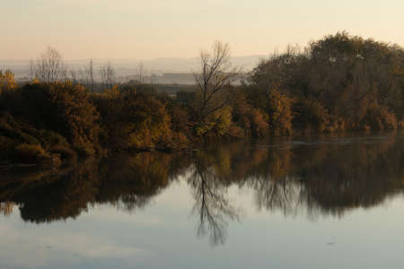 Natural autumn fluvial landscape of the Ebro River, as it passes through the small town of Gallur, in the Ribera Alta del Ebro region, Zaragoza province, Aragon, Spainの写真素材