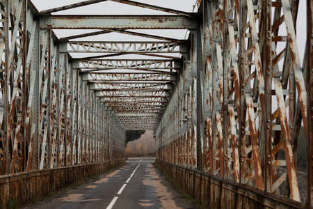 Old rusty iron bridge over the PeÃ±a reservoir, in the Jacetania region, Huesca province, Aragon, Spainの写真素材