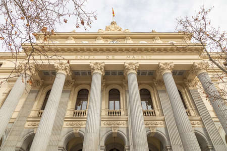 Madrid, Spain - Dec 27, 2020: Access area and facade of the main entrance of the building that houses the Madrid Stock Exchange, with its characteristic columns, in Plaza de la Lealtad, downtown areaのeditorial素材