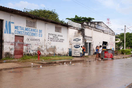 Cartagena de Indias, Colombia - Nov 21, 2010: Streets, warehouses and various mechanical workshops in Cartagena de Indias on a rainy dayのeditorial素材