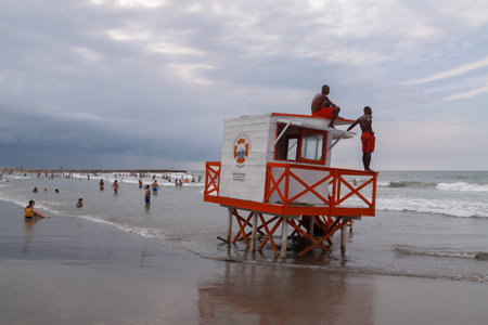 Cartagena de Indias, Colombia - Nov 21, 2010: Two lifeguards monitor bathers, on a stormy day, from the top of a watchtower on Bocagrande beachのeditorial素材