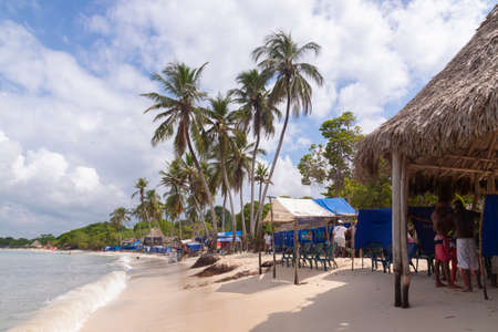 Cartagena de Indias, Colombia - Nov 22, 2010: Landscape of palm trees, chairs and half-empty bungalows on one of the beaches of Isla Baru, on a stormy day, in the Colombian Caribbeanのeditorial素材