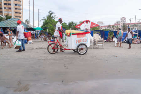 Cartagena de Indias, Colombia - Nov 21, 2010: A street vendor of ice cream and soft drinks, walks with his tricycle in search of customers on the Bocagrande beachのeditorial素材