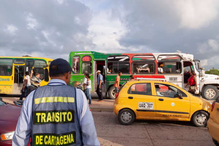 Cartagena de Indias, Colombia - Nov 23, 2010: A traffic agent tries to organize and monitor the arrival of buses and taxis near Avenida Venezuela, on the outskirts of the historic center of the cityのeditorial素材