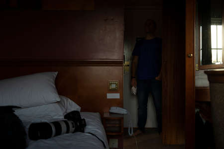 A man, self isolate, in solitude, in a hotel room, near Manchester airport, United Kingdom, awaits the results of a covid-19 pcr test that will liberate himの写真素材