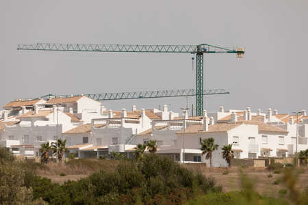 Zahara de los Atunes, Spain - Sept 06, 2021: An urbanization of villas and apartments for tourist purposes, painted white, near the coast, still unfinished, province of Cadizのeditorial素材