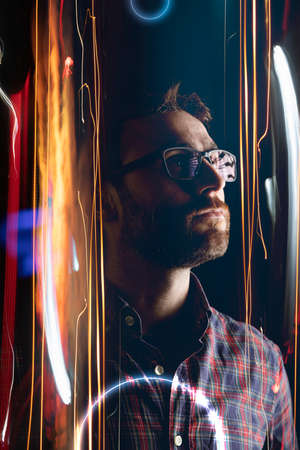 A self-confident man enters the metaverse through a virtual portal, projected in the form of lights...