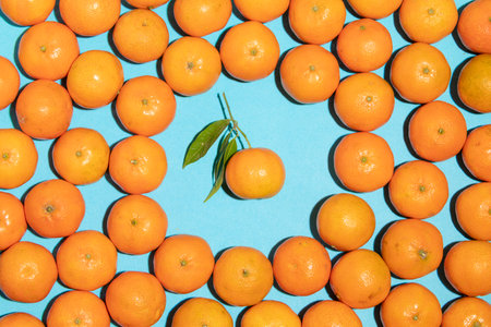 Juicy and natural tangerines texture with one in the middleの写真素材