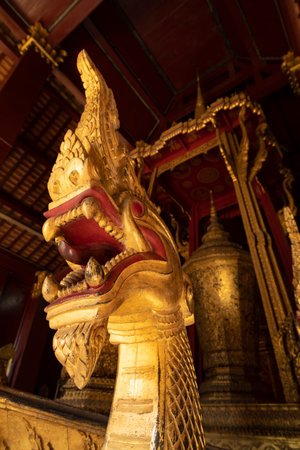 Ancient religious ceremonial barge, with golden representations of fearsome snake-like Nagas, inside...
