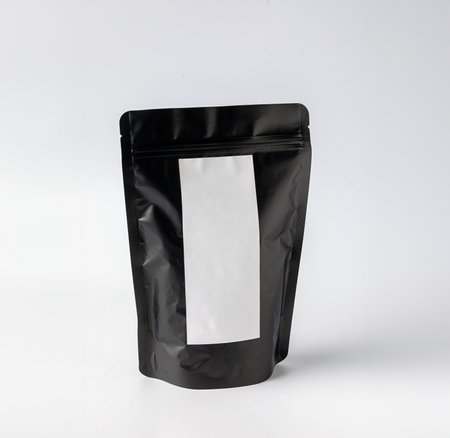Mockup of a black coffee or tea bag packaging, common for sale in specialized stores and cafes, white backgroundの写真素材