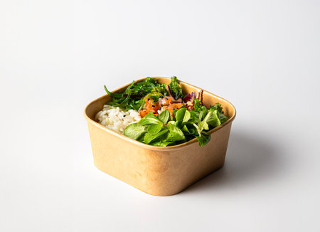 Healthy poke bowl with rice, algae, bites of salmon, and fresh vegetablesの写真素材