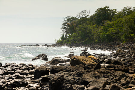 Landscape of a rocky beach covered by tropical jungle, south of the island of Pulau Weh, Sumatra, Indonesiaの写真素材
