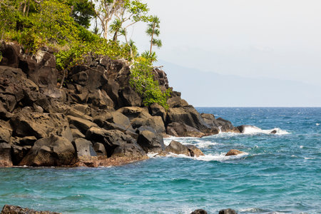 Rocky natural coastal landscape bathed by the Indian Ocean, on the island of Pulau Weh, in Sumatra, Indonesiaの写真素材