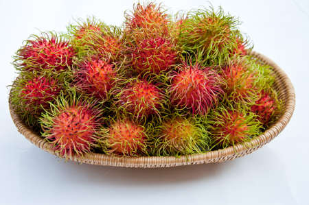 Rambutan in basket on white backgroundの写真素材