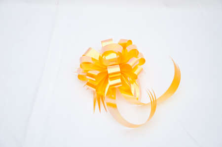 Yellow bow on white backgroundの写真素材