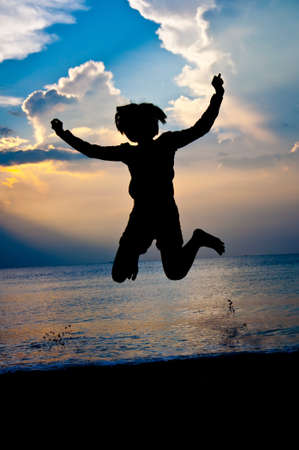 silhouette of girl feel free and happy  on the beachの写真素材