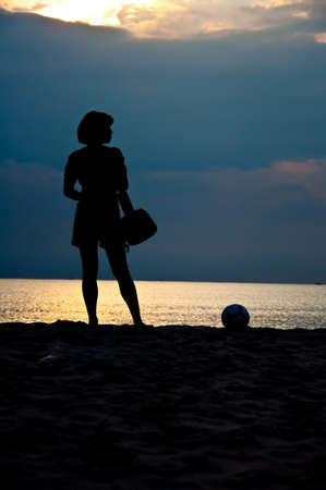 silhouette of girl stand on the beachの写真素材