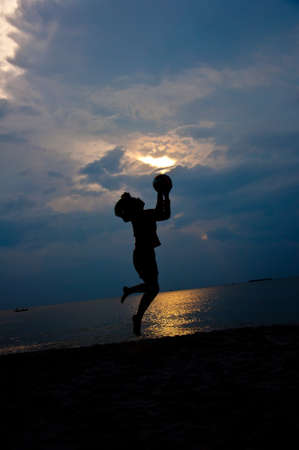 silhouette of girl feel free on the beachの写真素材